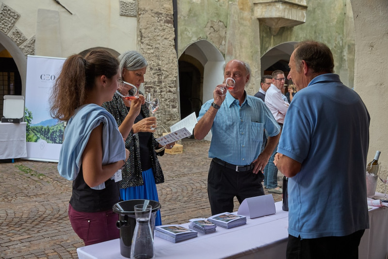 A photo of people tasting the wine at the Wine and Arcades event
